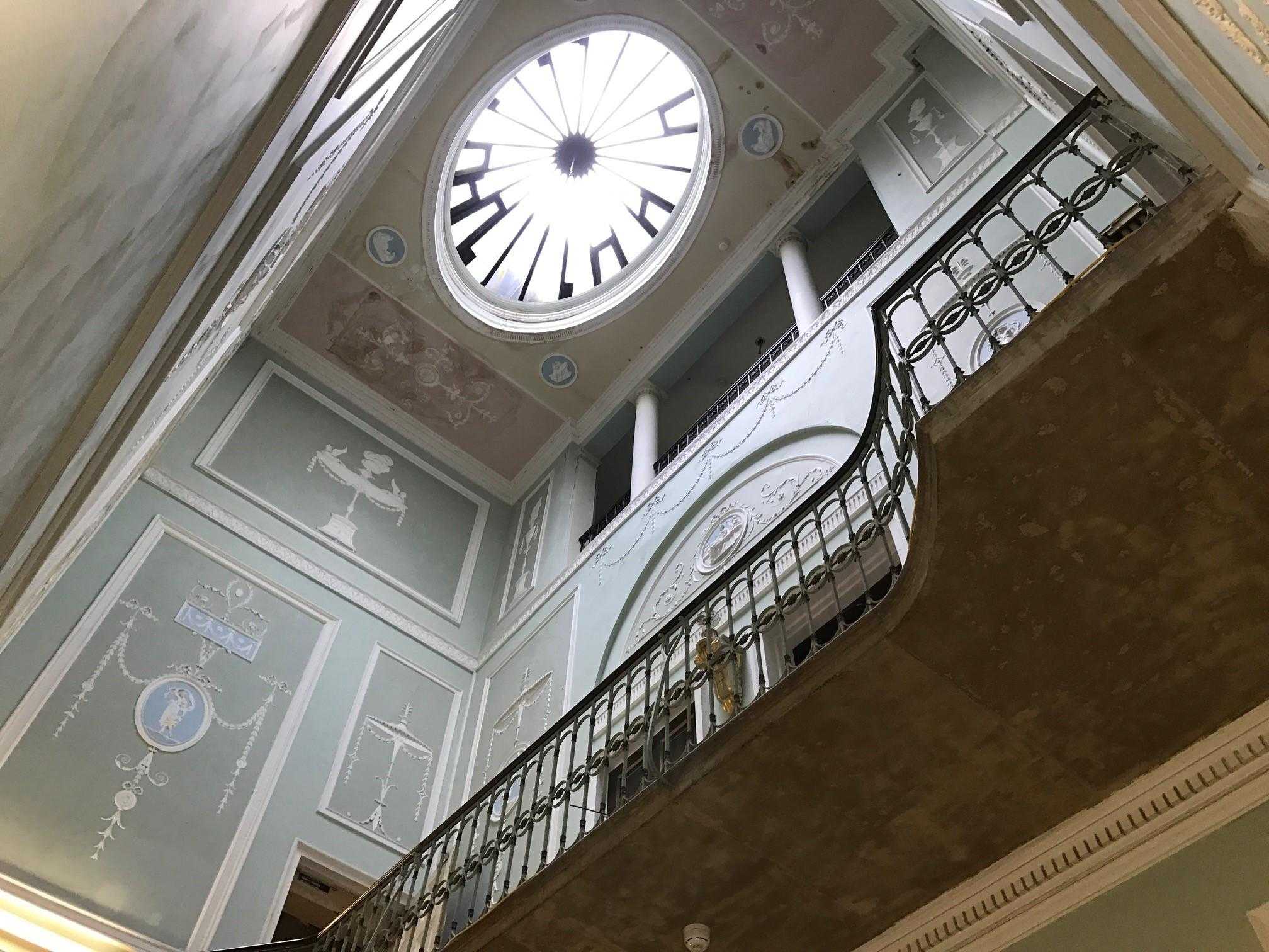 The oval rooflight and stair balustrade at 33 Portland Place, seen from below against Adam plasterwork.