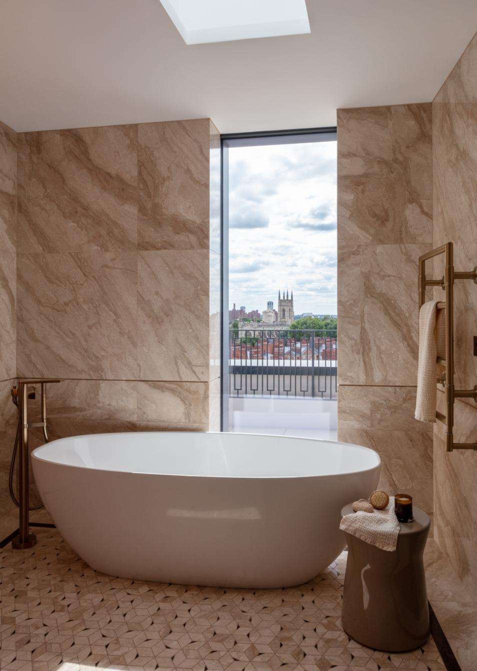 Completed apartment bathroom at Lucan Place with a freestanding bath and full-height marble.