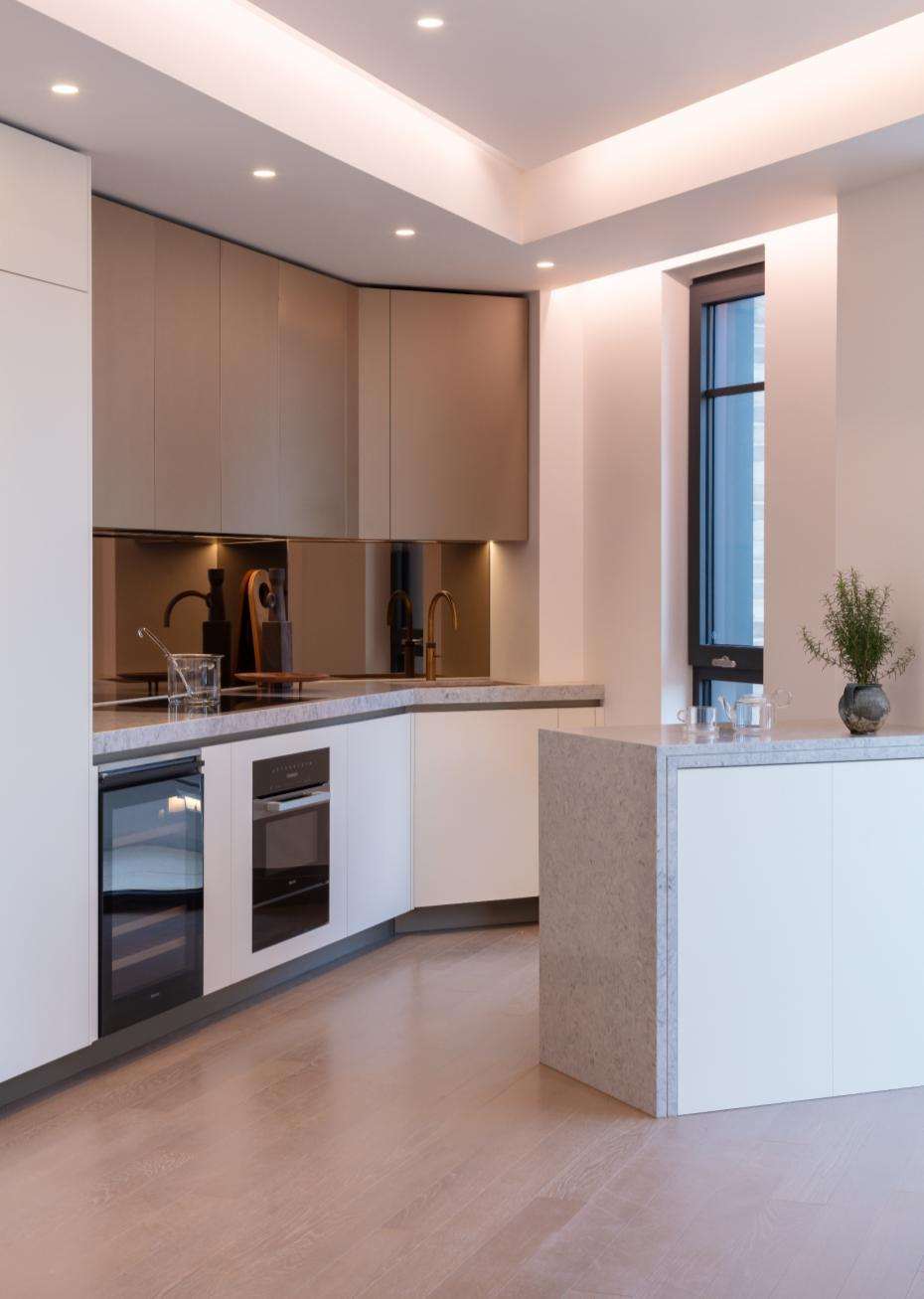 Completed apartment kitchen at Lucan Place with an island and integrated appliances.
