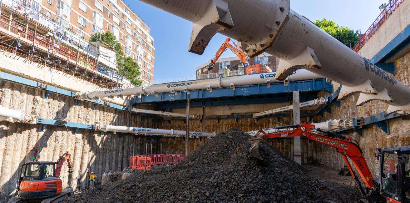 Wide view across the Lucan Place basement excavation showing the propping arrangement against neighbouring mansion blocks.