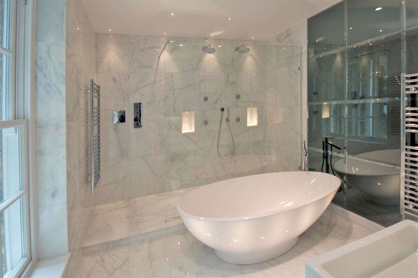 A marble bathroom at Soho Square with a freestanding bath and walk-in shower.