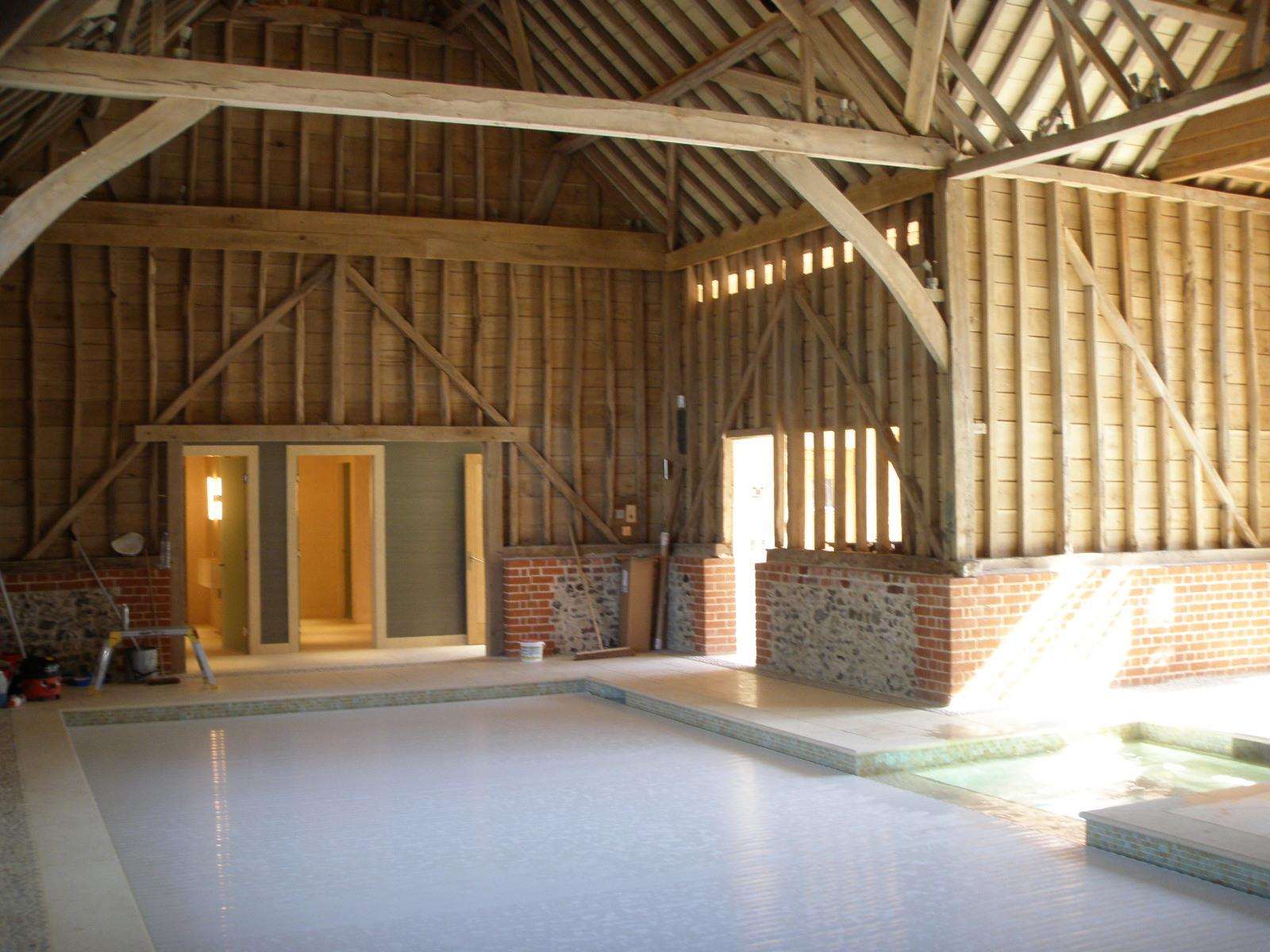 The oak barn interior at Huttons Farm with the frame and trusses left exposed.