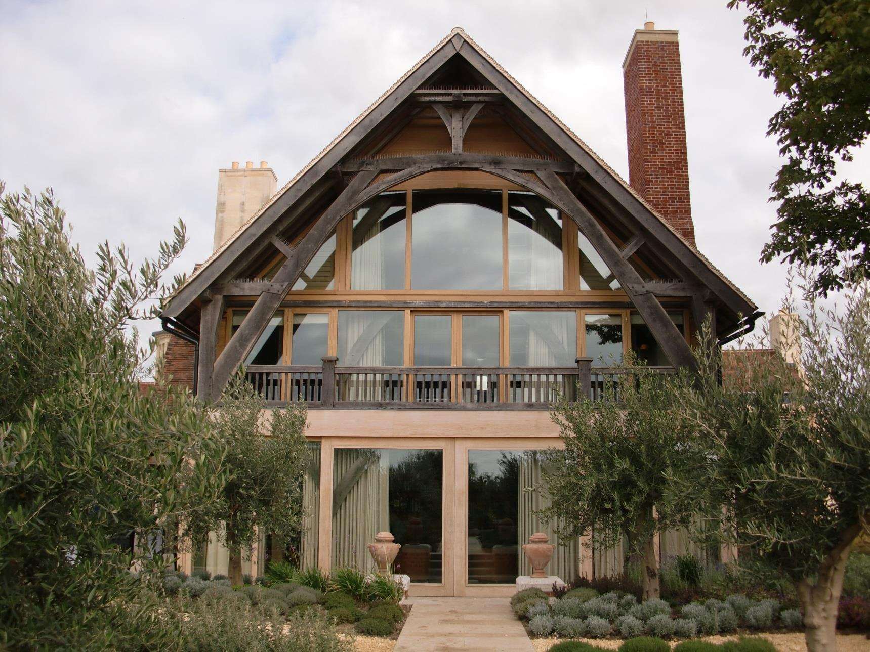 The oak-framed gable at Huttons Farm, fully glazed beneath an exposed truss.