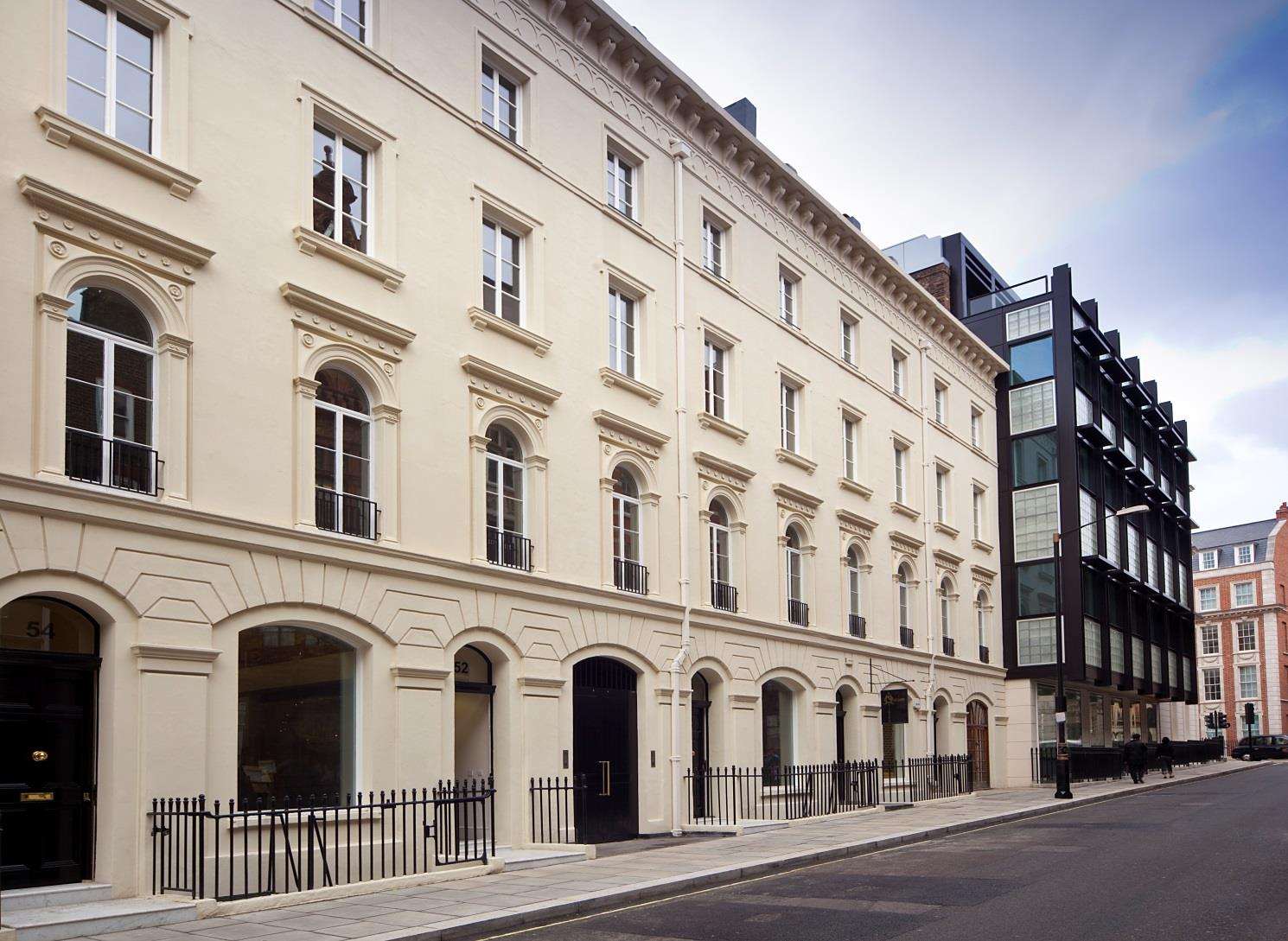 The Portland stone elevation on New Bond Street after refurbishment, with a black glazed shopfront below.