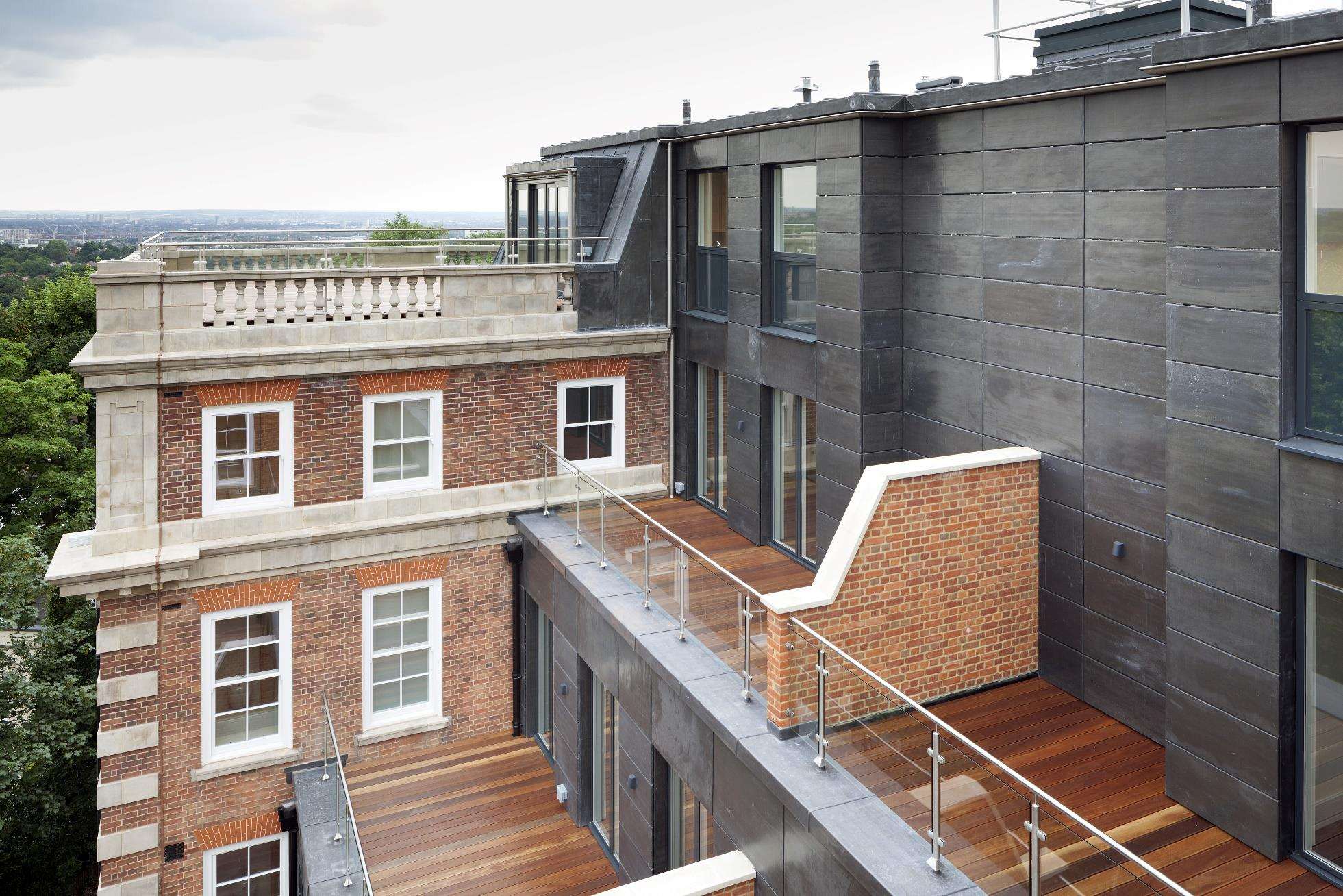 The slate-clad contemporary extension at One Highgate set against the original brickwork.